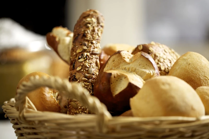 Variety of fresh bread rolls: bread rolls, poppy seed, sesame and pretzel rolls